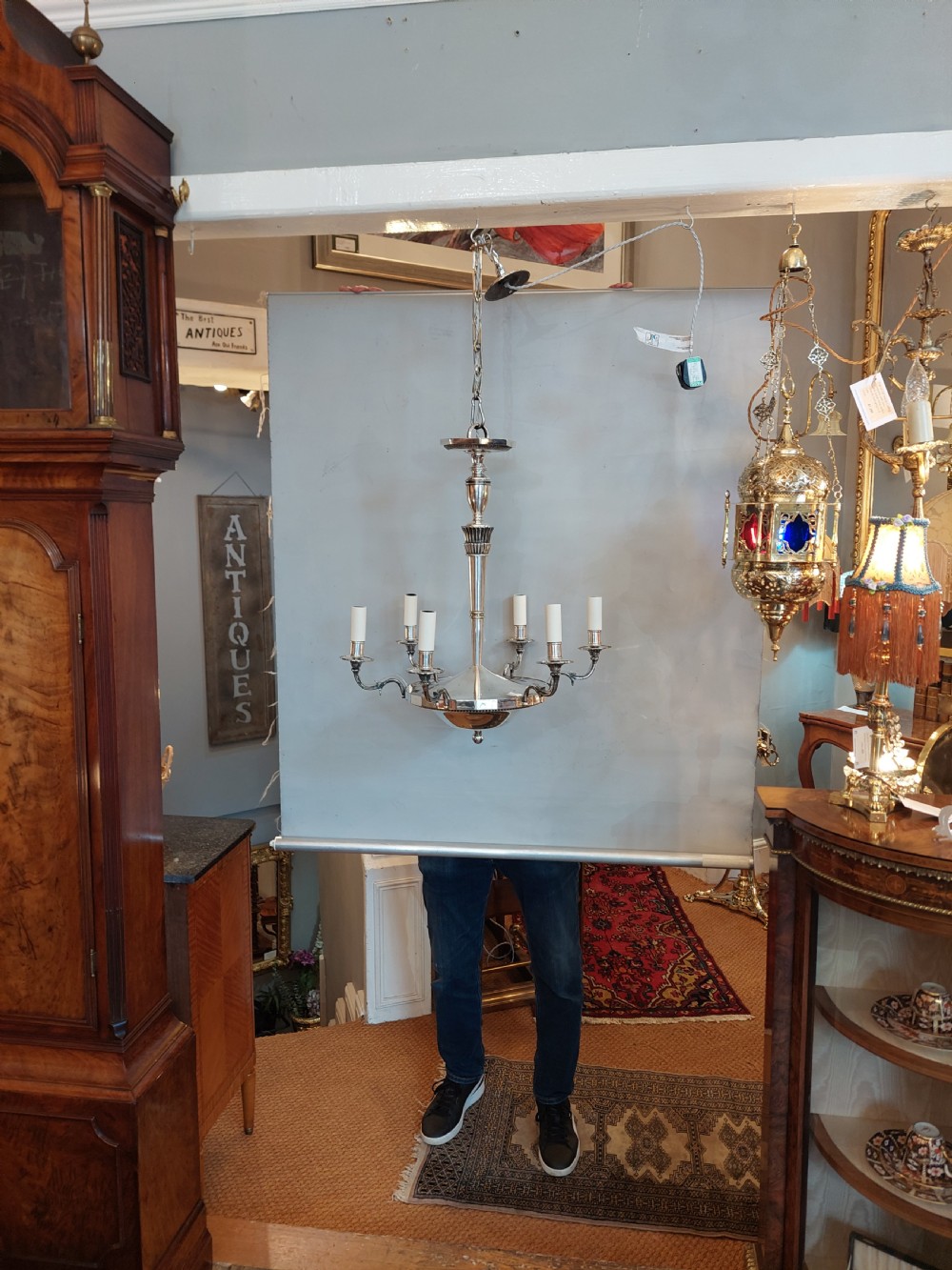 An early twentieth-century silver-plated six-arm ceiling chandelier featuring candle-style light sockets and a central fluted column. View III