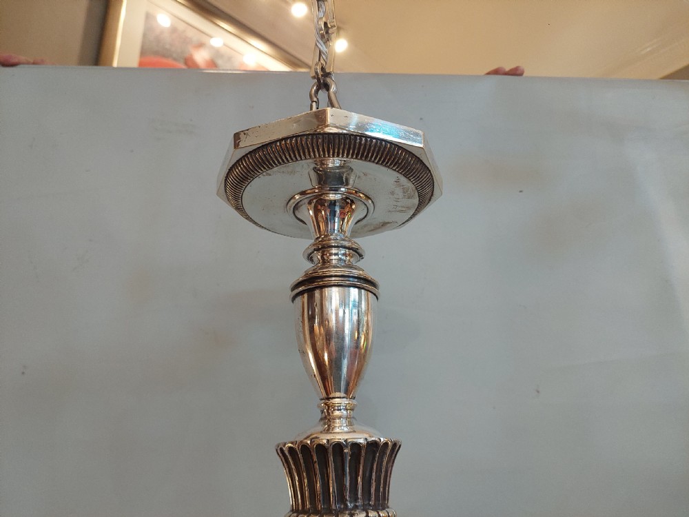 An early twentieth-century silver-plated six-arm ceiling chandelier featuring candle-style light sockets and a central fluted column. View IV
