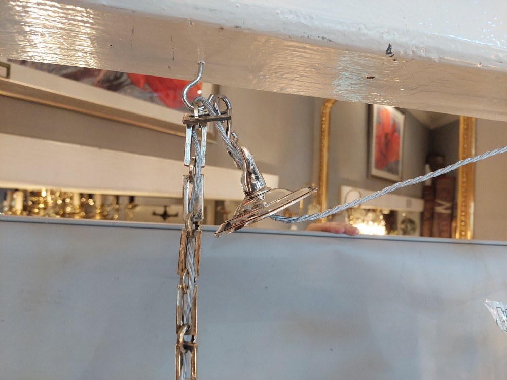 An early twentieth-century silver-plated six-arm ceiling chandelier featuring candle-style light sockets and a central fluted column. View VI