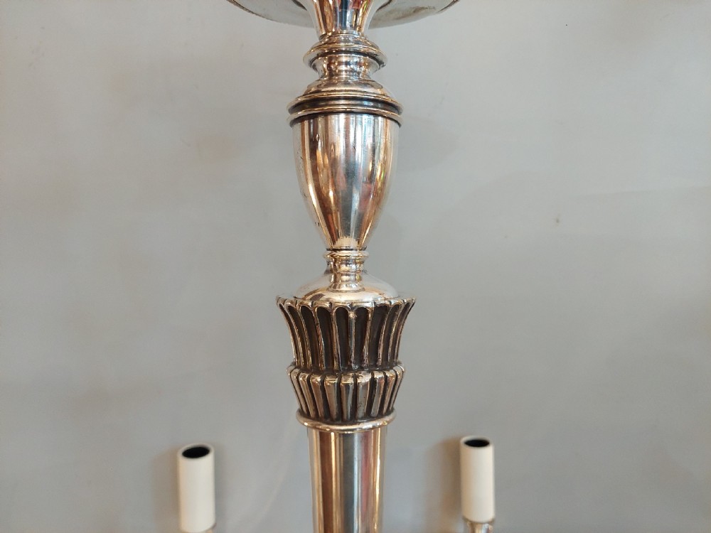 An early twentieth-century silver-plated six-arm ceiling chandelier featuring candle-style light sockets and a central fluted column. View VII