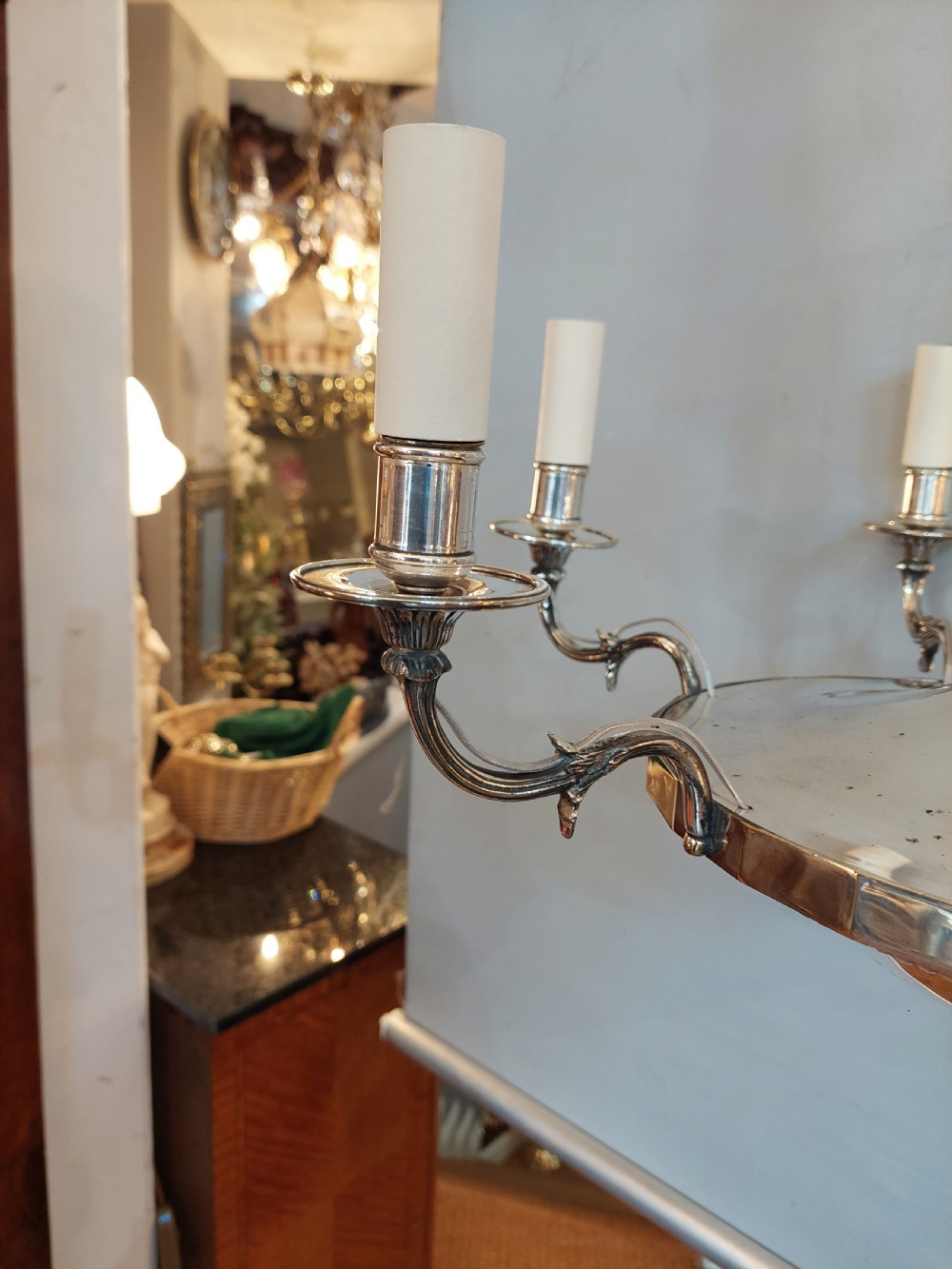 An early twentieth-century silver-plated six-arm ceiling chandelier featuring candle-style light sockets and a central fluted column. View IX