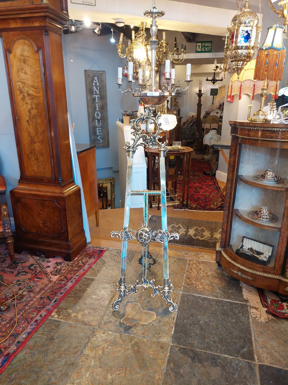 An early twentieth-century silver-plated six-arm ceiling chandelier featuring candle-style light sockets and a central fluted column. View XI
