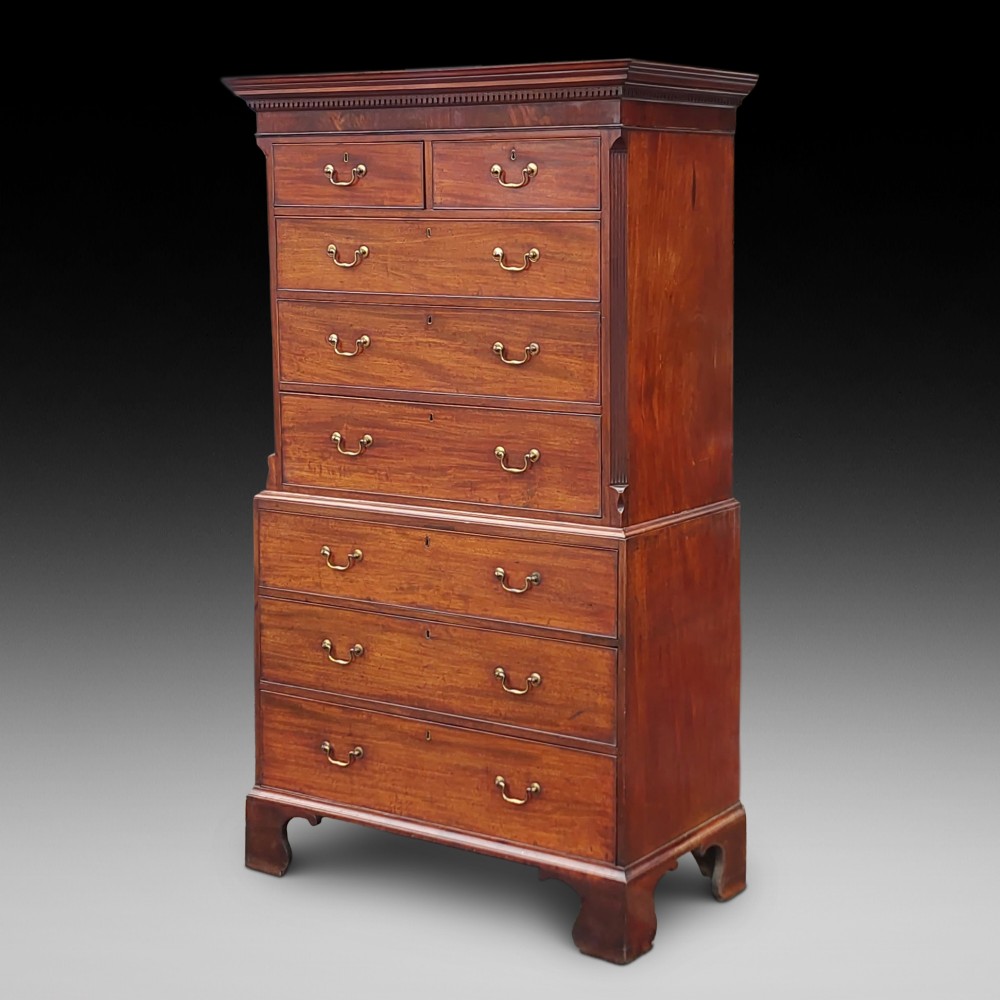 A late 18th-century Georgian mahogany tallboy chest on chest with brass swan-neck handles and bracket feet.