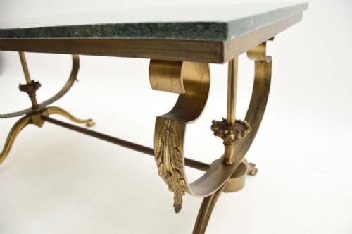 fig 1. A rectangular French coffee table featuring a green marble top resting on a brass frame with curved legs and acanthus leaf ornamentation.