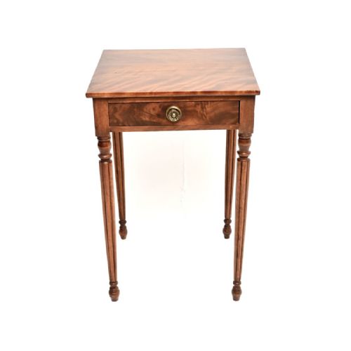 fig 1. A Georgian walnut side table featuring a single drawer with a round brass handle and four slim fluted turned legs.