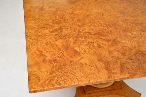 fig 1. A square Swedish Biedermeier coffee table featuring a figured golden birch veneered top supported by a central black ebonised column on a concave quadform base with ebonised ball feet.