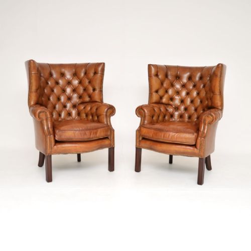 PAIR OF ANTIQUE LEATHER BARREL BACK WING ARMCHAIRS