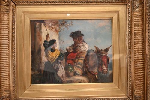 fig 2. A nineteenth-century framed oil painting depicting figures in traditional dress alongside a donkey, housed in an ornate carved gold giltwood frame.