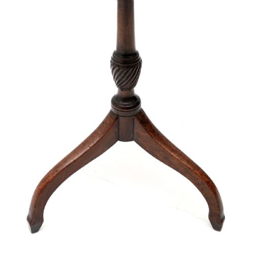 fig 1. A Georgian mahogany snap-top occasional table featuring a circular molded top supported on a turned central stem with spiralled carving and three splayed tripod legs.
