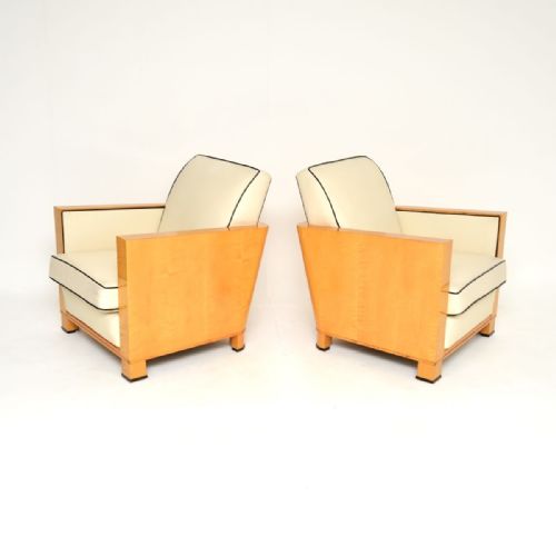 fig 1. A pair of Swedish Art Deco armchairs with blonde satin birch side panels and cream leather upholstery detailed with black contrast piping.