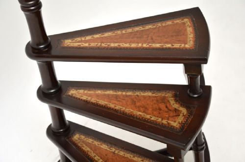 fig 1. Antique spiral mahogany library steps featuring four gold-tooled leather treads and a central turned support pole topped with a brass finial.