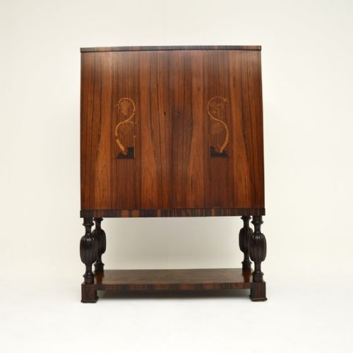 fig 1. A vintage Swedish rosewood cabinet featuring two tall doors with inlaid botanical marquetry, raised on turned baluster legs above an open lower shelf.