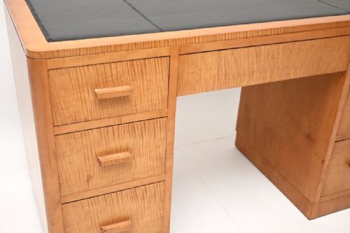 fig 1. An Art Deco twin pedestal desk constructed from light honey-coloured satin birch with a black leather inset top and matching wooden drawer handles.