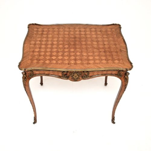 fig 1. A French Louis XV style parquetry bureau plat featuring cabriole legs, diamond-pattern inlaid wood, and gilded bronze mounts.