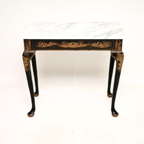 fig 1. A rectangular Victorian side table featuring a white veined marble top resting on a black lacquered apron and cabriole legs decorated with gold Chinoiserie gilding.