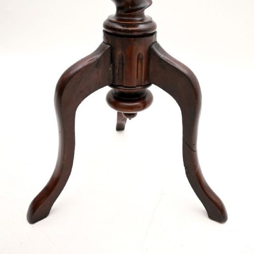 fig 1. A small antique mahogany occasional table featuring a circular top, a single barley twist column, and a three-legged tripod base.