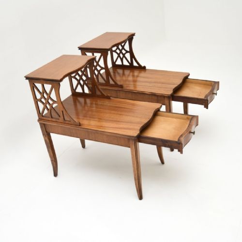 fig 1. A pair of warm brown mahogany two-tier side tables featuring carved lattice fretwork supports and tapered legs.