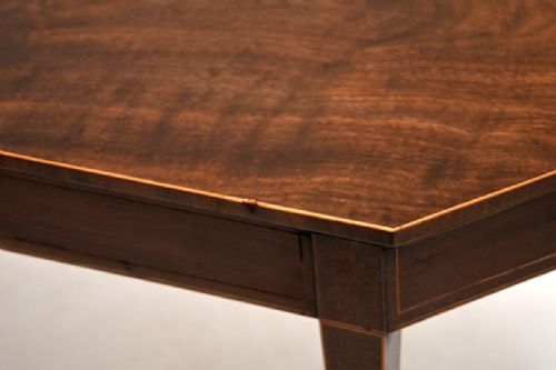 fig 2. A Georgian mahogany console table featuring canted corners, boxwood stringing, and tapered square legs.