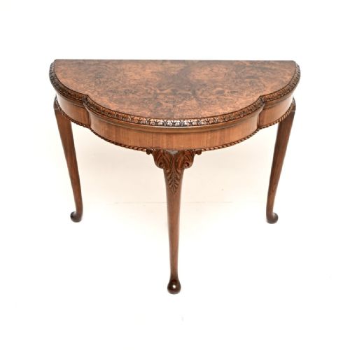 fig 1. A Queen Anne style burr walnut fold-over card table featuring cabriole legs with carved knee accents and pad feet.