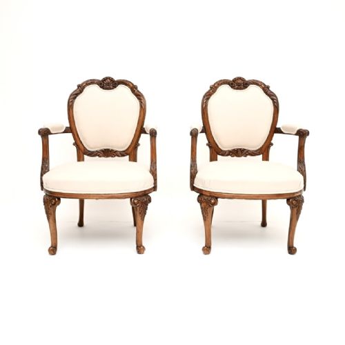 fig 1. A pair of carved walnut salon armchairs with off-white fabric upholstery and cabriole legs.