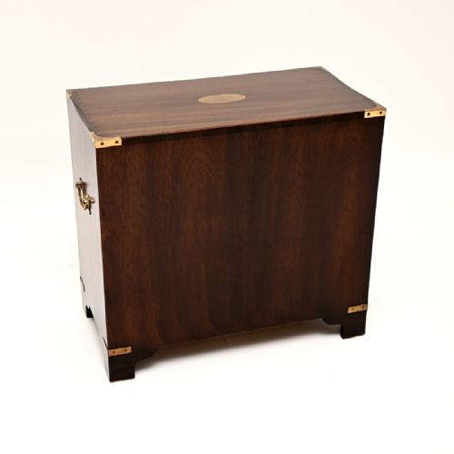 fig 1. A dark mahogany three-drawer military campaign chest featuring flush brass corner mounts and brass drop handles.