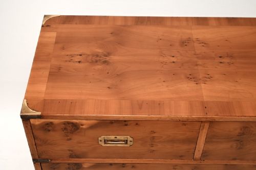 fig 1. An antique yew wood military campaign chest of drawers featuring two modular sections with flush brass handles and protective corner fittings.