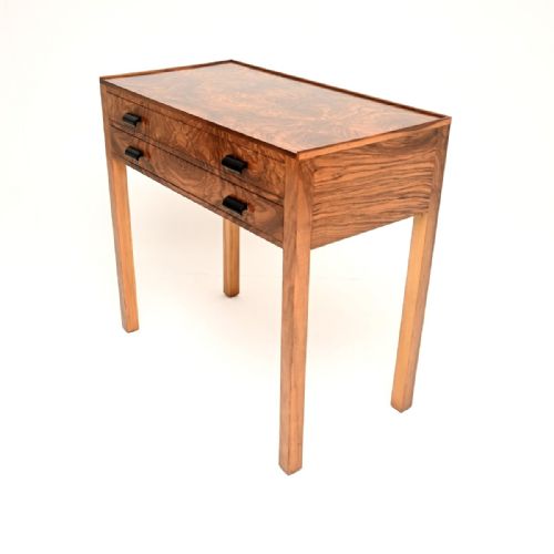 fig 1. An Art Deco burr walnut console table with two drawers, dark cylindrical handles, and straight square legs.
