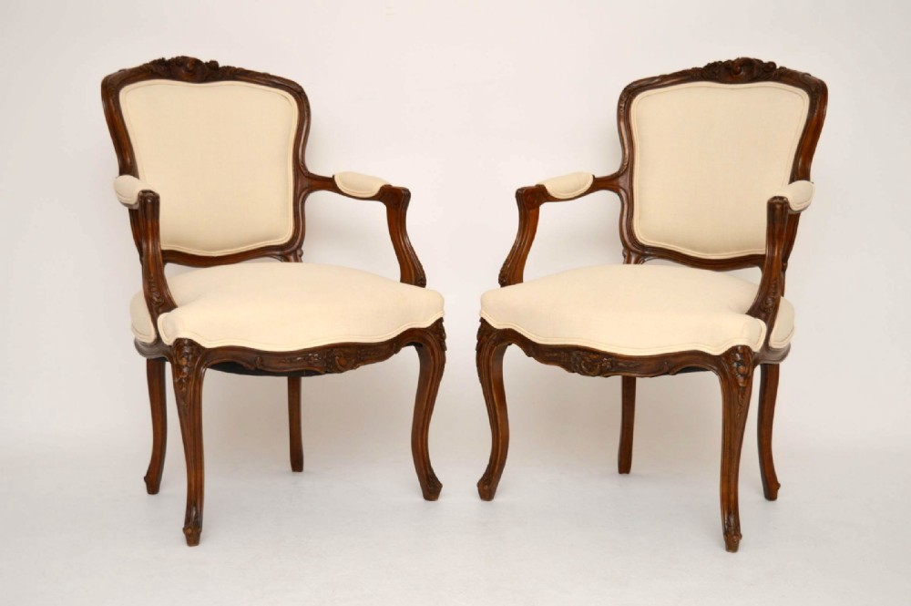 Pair of French Antique Carved Walnut Salon Armchairs