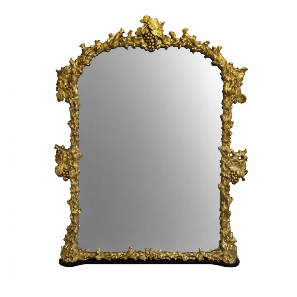 An 18th-century Italian giltwood wall mirror featuring a deeply carved frame ornamented with grapevine and leaf motifs surrounding an arched central glass panel.
