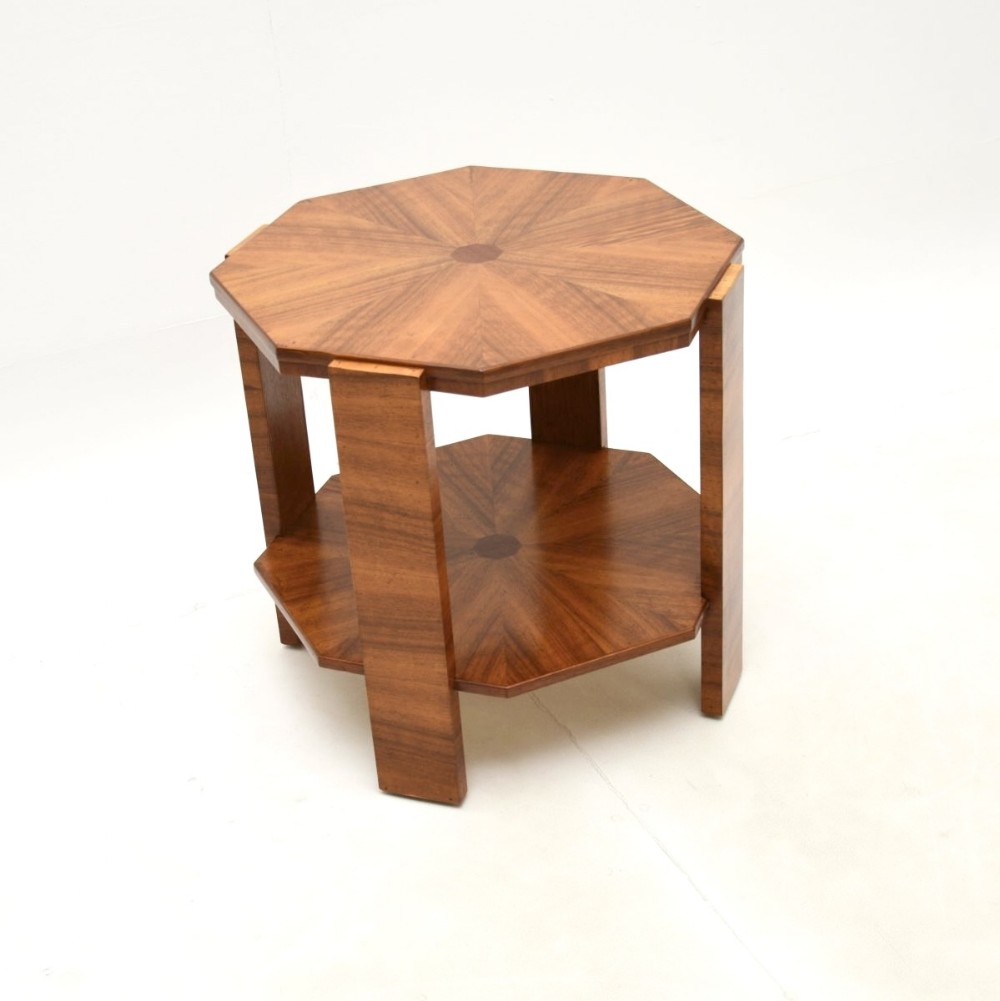An octagonal Art Deco walnut side table featuring a starburst veneer top, lower tier shelf, and four straight legs.