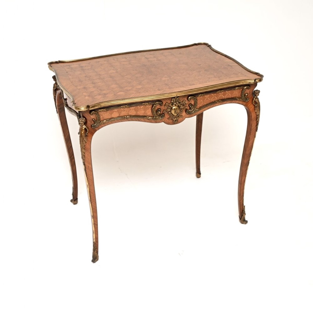 A French Louis XV style parquetry bureau plat featuring cabriole legs, diamond-pattern inlaid wood, and gilded bronze mounts.