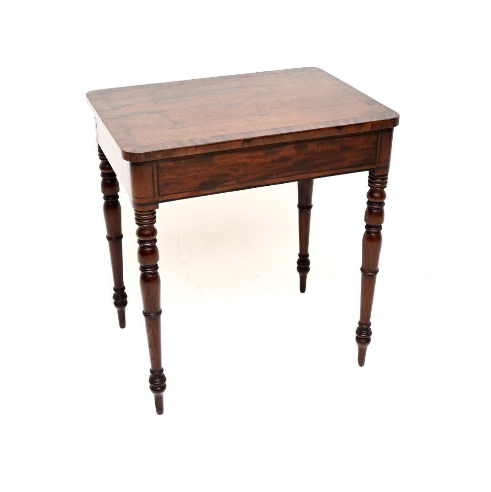 A rectangular Georgian mahogany side table featuring a polished wood surface resting on four slim turned legs.