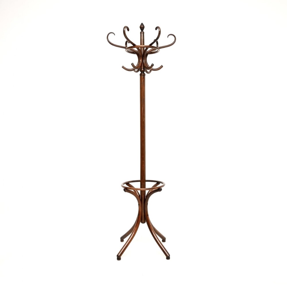 A dark brown bentwood hat stand with multiple upper curved hooks, a central turned post, and a lower circular umbrella ring with splayed legs.