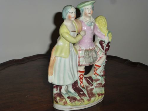 A STAFFORDSHIRE FLATBACK FIGURE OF SCOTTISH LAIRD AND HIS WIFE - ADDITIONAL PHOTO 1
