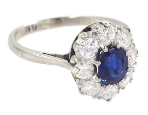 fig 1. An Art Deco platinum cluster ring featuring a central oval blue sapphire surrounded by a halo of round diamonds.