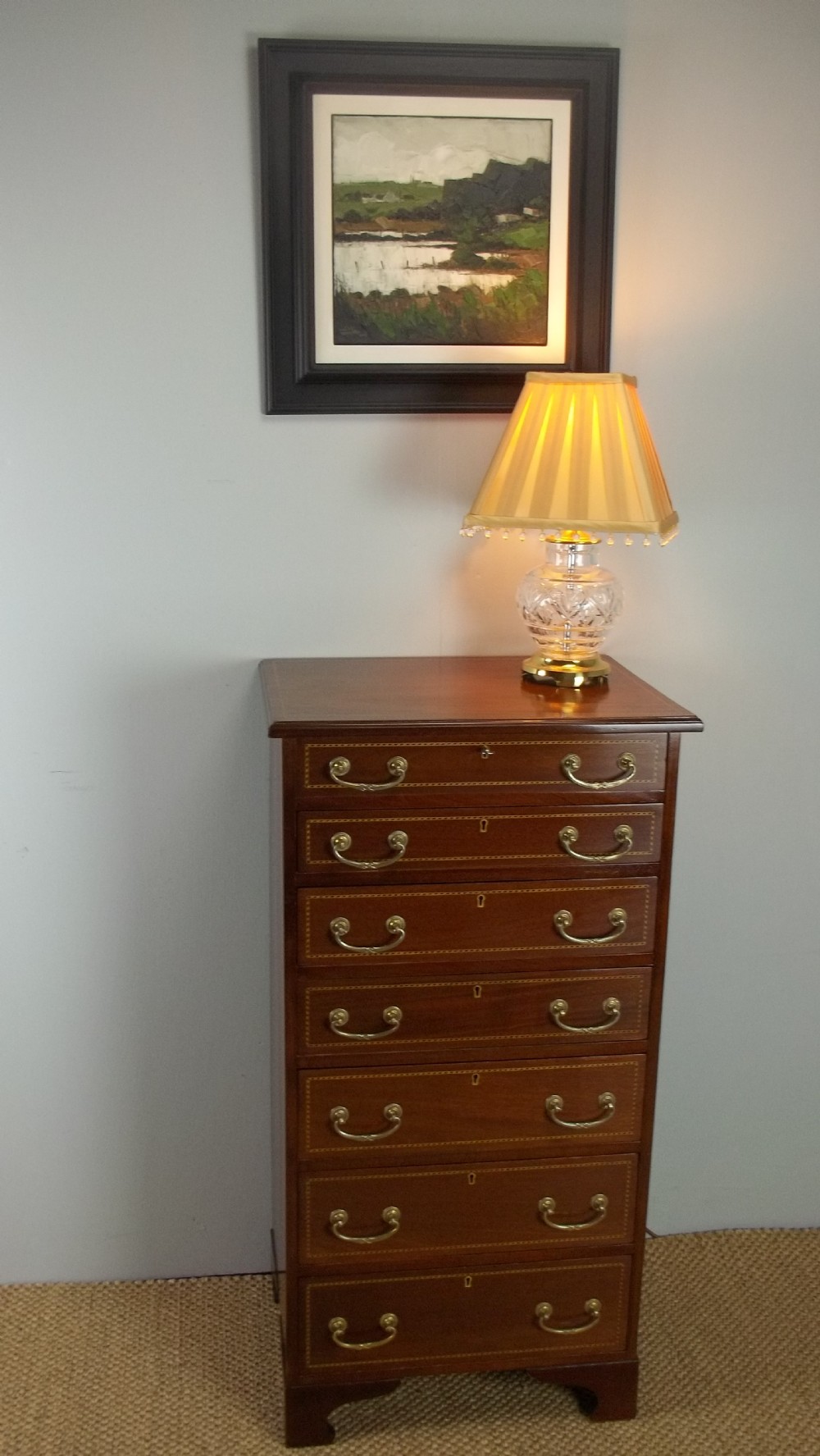 A £2250 Mahogany inlaid narrow tall small wellington chest of drawers. C.1895.