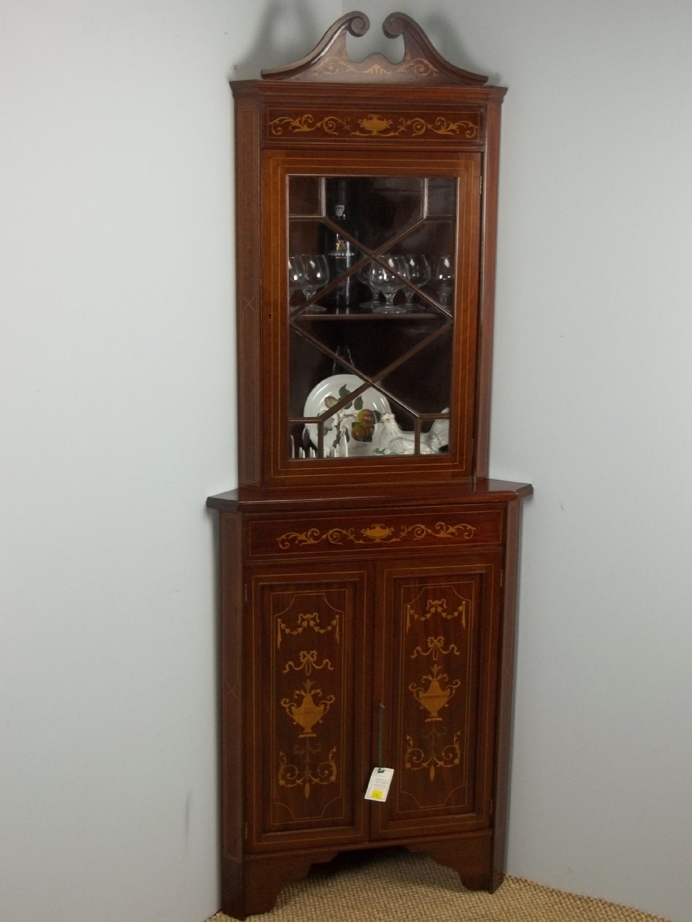 Antique mahogany Edwardian marquetry inlaid two piece standing double height corner display glazed cabinet cupboard. C.1900.