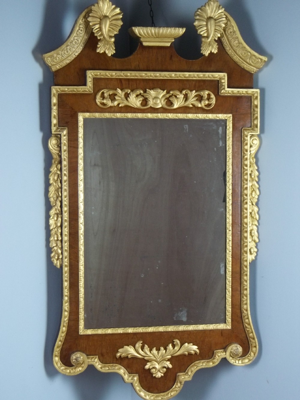 A large 18th/19th century walnut and parcel gilt wood fret wall pier console mirror of William Kent George II design. 
