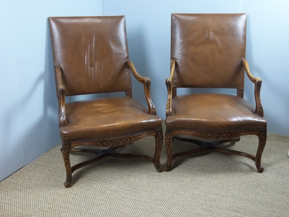 A fabulous pair of leather upholstered 19th century walnut framed Gainsborough French Fauteuil easy open elbow library reading armchairs. C.1890.