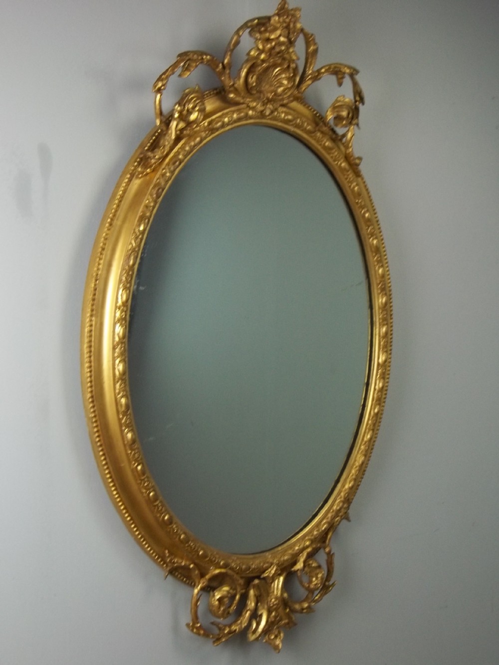A fabulous quality large 19th century oval water gilt wall mirror gilded looking glass. C.1850.