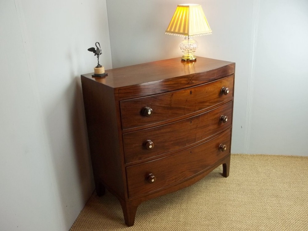 A small bowfront inlaid antique Regency caddy top Georgian mahogany chest of drawers of bow front form