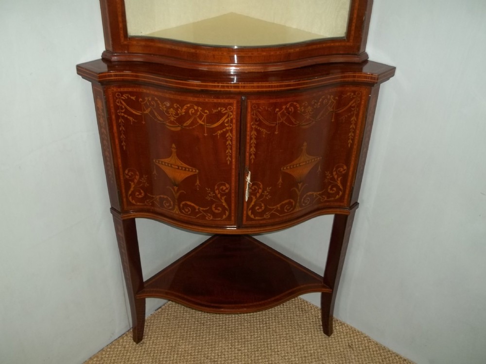 Antique Edwards and Roberts mahogany marquetry inlaid serpentine fronted corner double height standing corner display cabinet cupboard. C.1900 View II