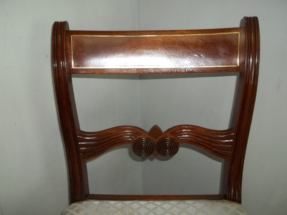 A superb antique set of Georgian 8 eight ( six plus two) Regency brass inlaid mahogany upholstered dining chairs View VI