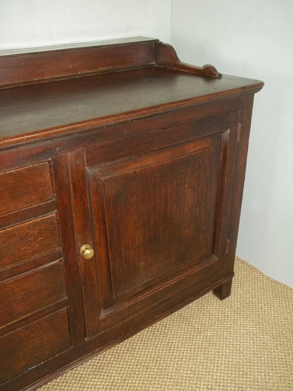 A Welsh Geo II early 18th century Georgian oak dresser base with spice drawers serving table sdieboard.  View II