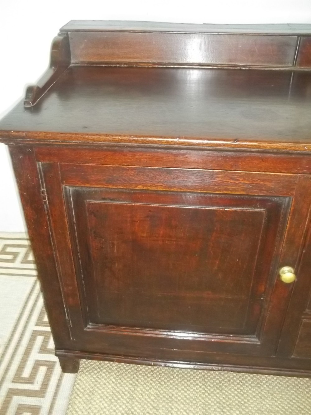 A Welsh Geo II early 18th century Georgian oak dresser base with spice drawers serving table sdieboard.  View III