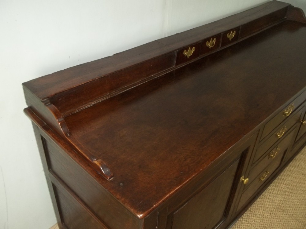 A Welsh Geo II early 18th century Georgian oak dresser base with spice drawers serving table sdieboard.  View IV