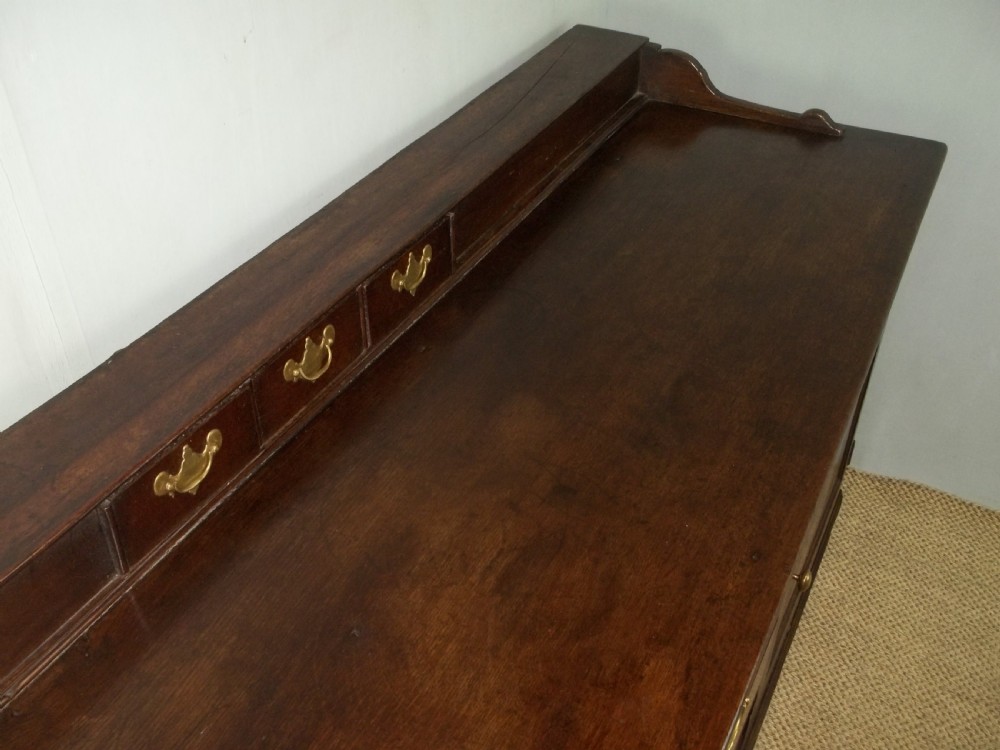 A Welsh Geo II early 18th century Georgian oak dresser base with spice drawers serving table sdieboard.  View V