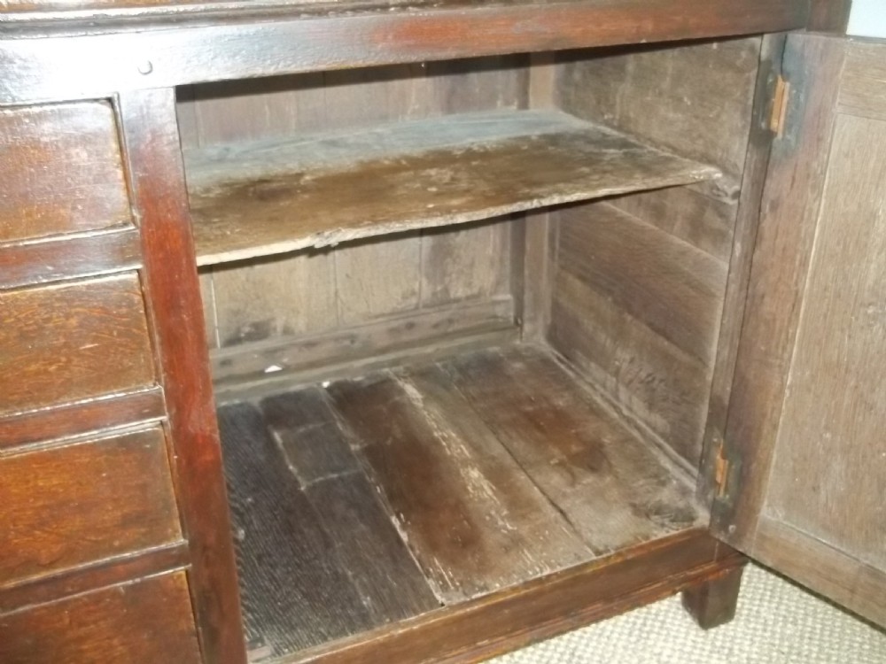 A Welsh Geo II early 18th century Georgian oak dresser base with spice drawers serving table sdieboard.  View VII