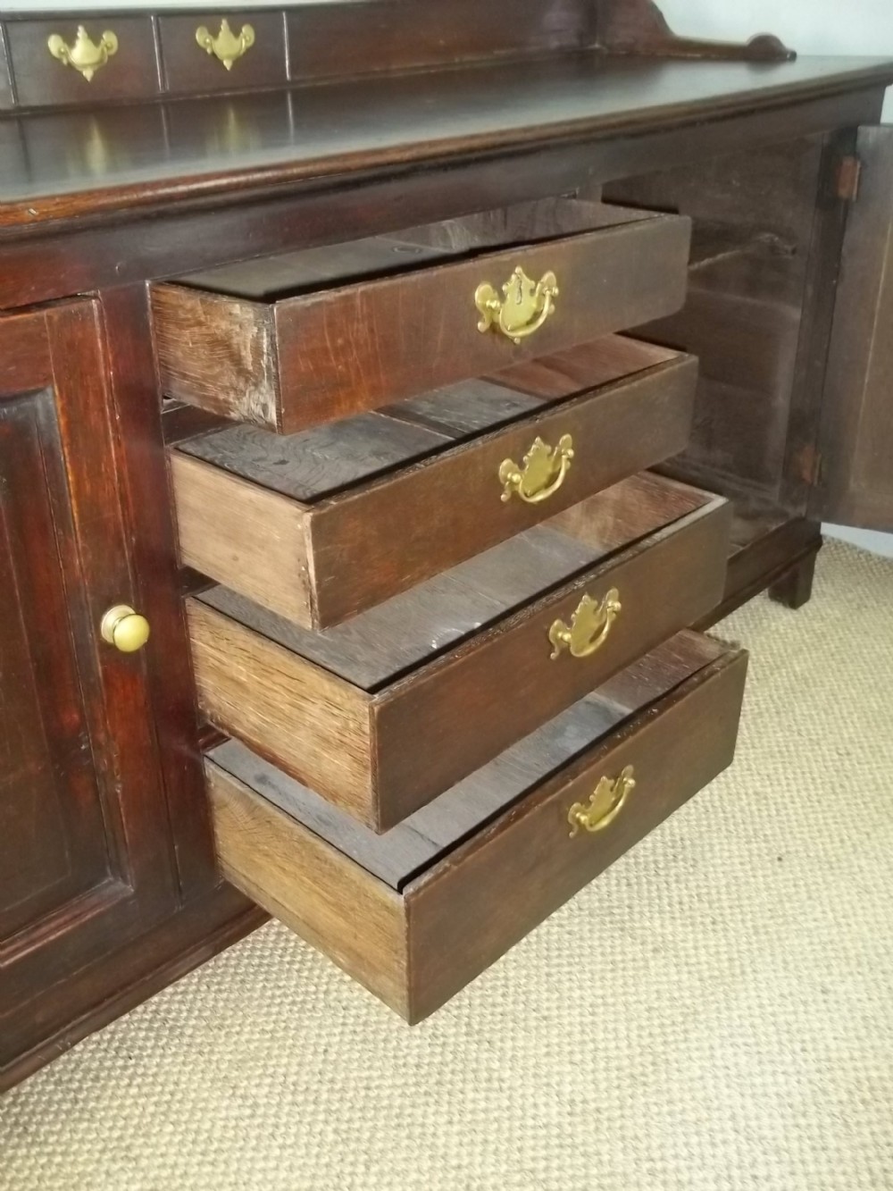 A Welsh Geo II early 18th century Georgian oak dresser base with spice drawers serving table sdieboard.  View IX