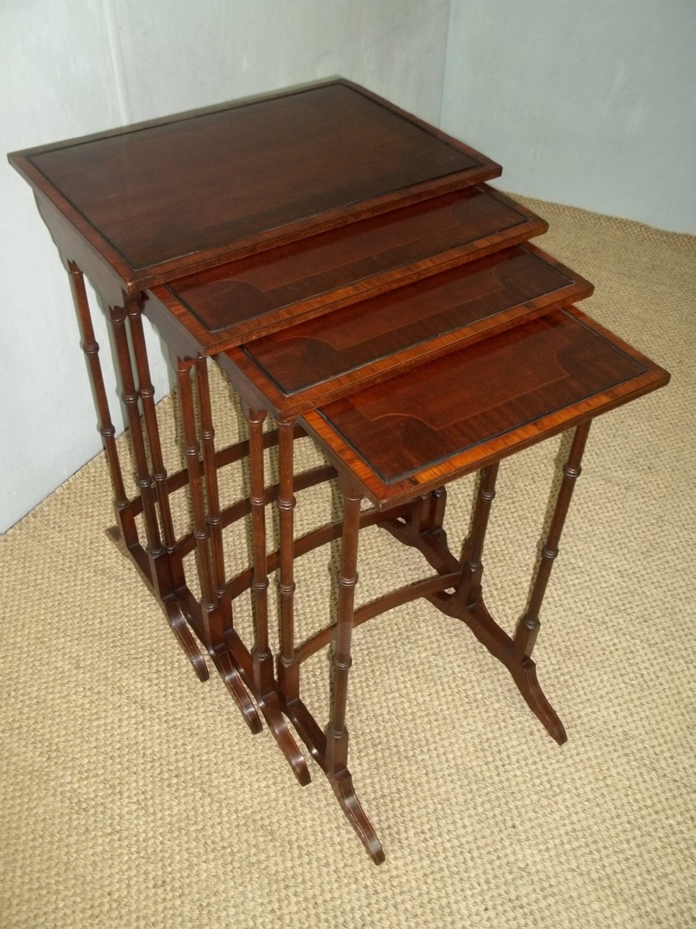 A late 19th/early 20th century set of mahogany inlaid quartetto nest of four stacking coffee side wine sofa tables 